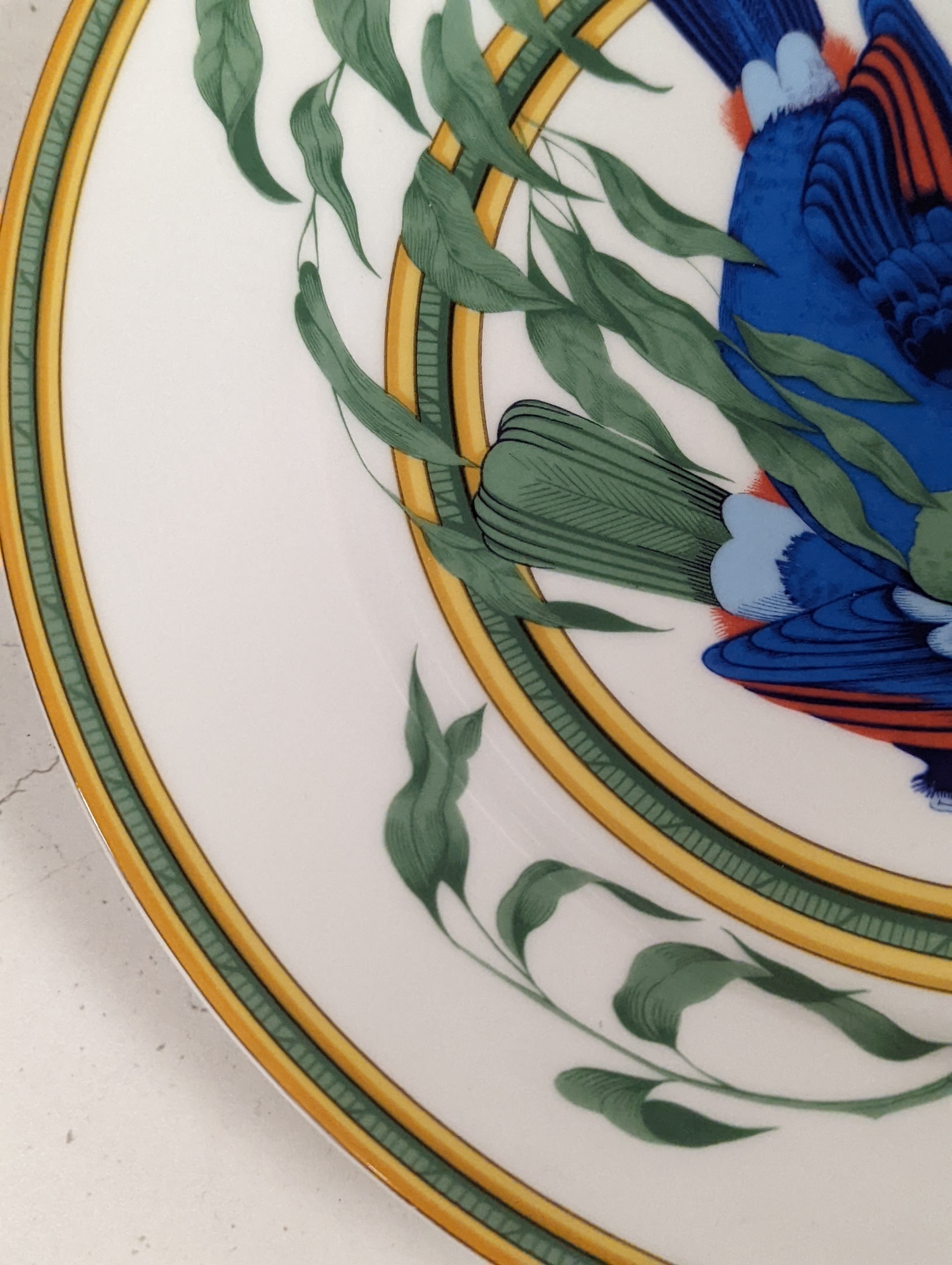 A pair of Hermes, Paris 'Toucan' plates, diameter 27.5cm, edge blemishes